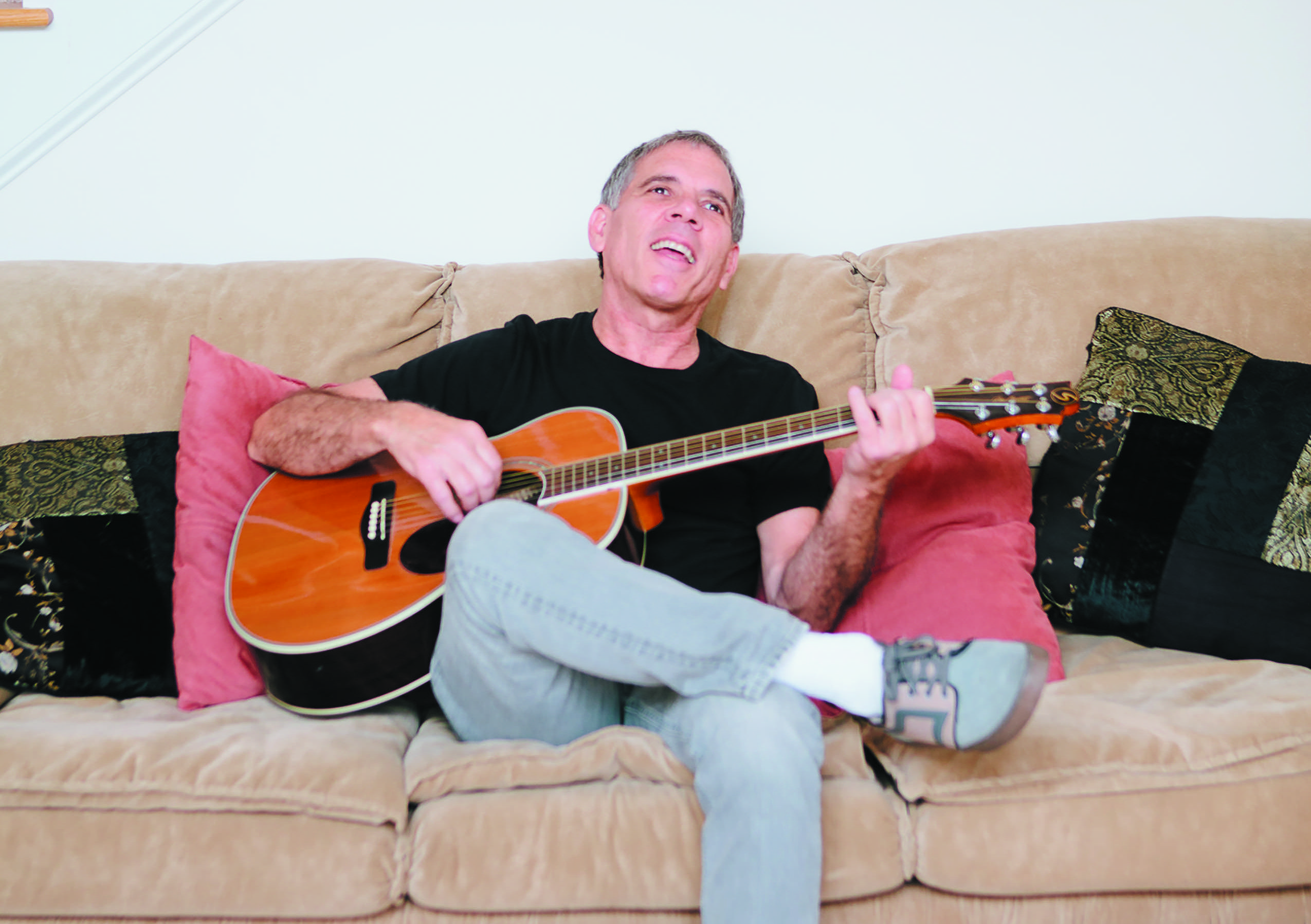Don Stewart with his guitar at home in Durham.