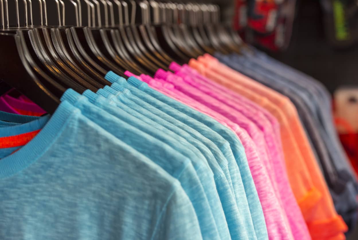 Row of colored t-shirts in a store