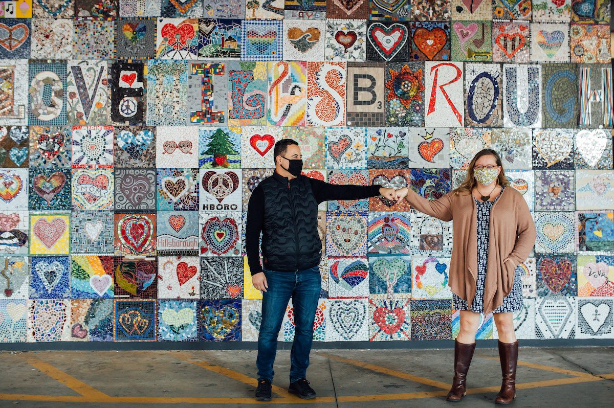 Katie and Carlos in front of mural