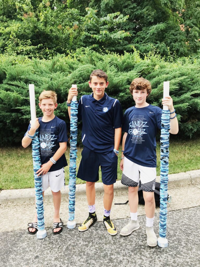 Porter, Zac and James with storage tubes they keep bracelets on