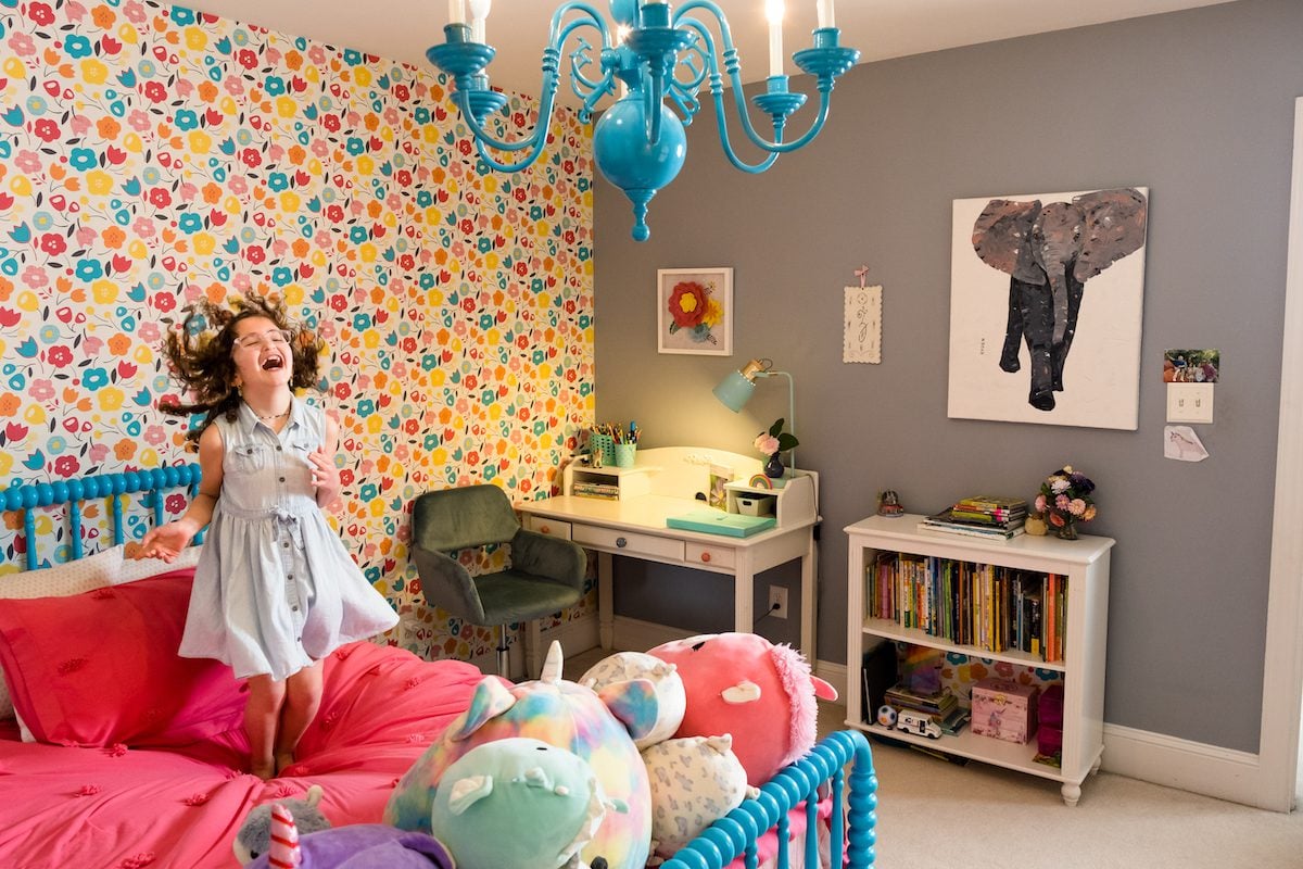 The wallpaper from Spoonflower was the anchor in Zoey’s room. Lisa then spray-painted a chandelier and the bedframe a corresponding shade of blue to match.