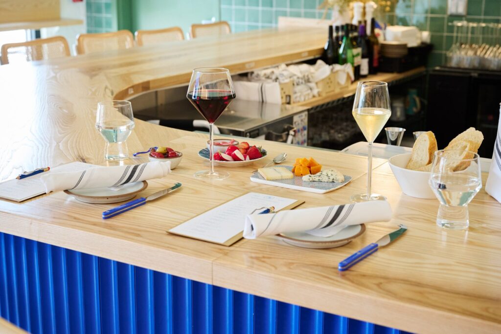 Place setting with wine and cheese at a horseshow bar