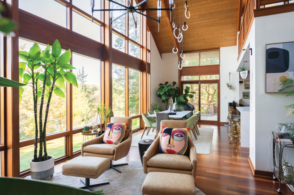 Interior designer Ana Tavares's living room features Picasso-style faces adorning pillows that lay atop leather swivel chairs and matching ottomans.