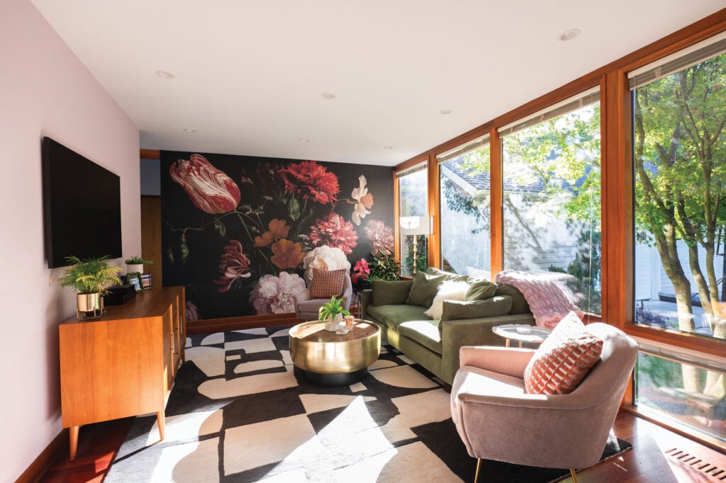 Interior designer Ana Travares's living room featuring an accent wall and abstract checkered floors.