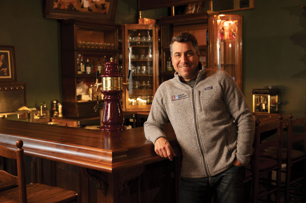 The Regulator owner D.L. Brown leans against the bar.