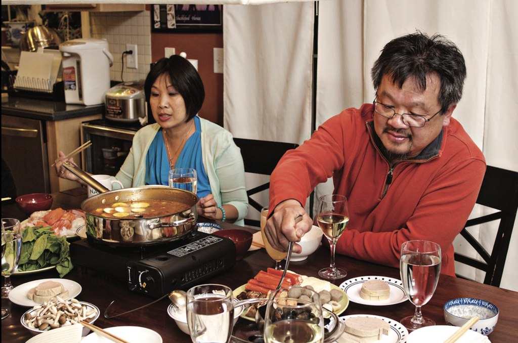 Michael Chuong enjoying food after cooking his past recipe of Vietnamese hot pot broth