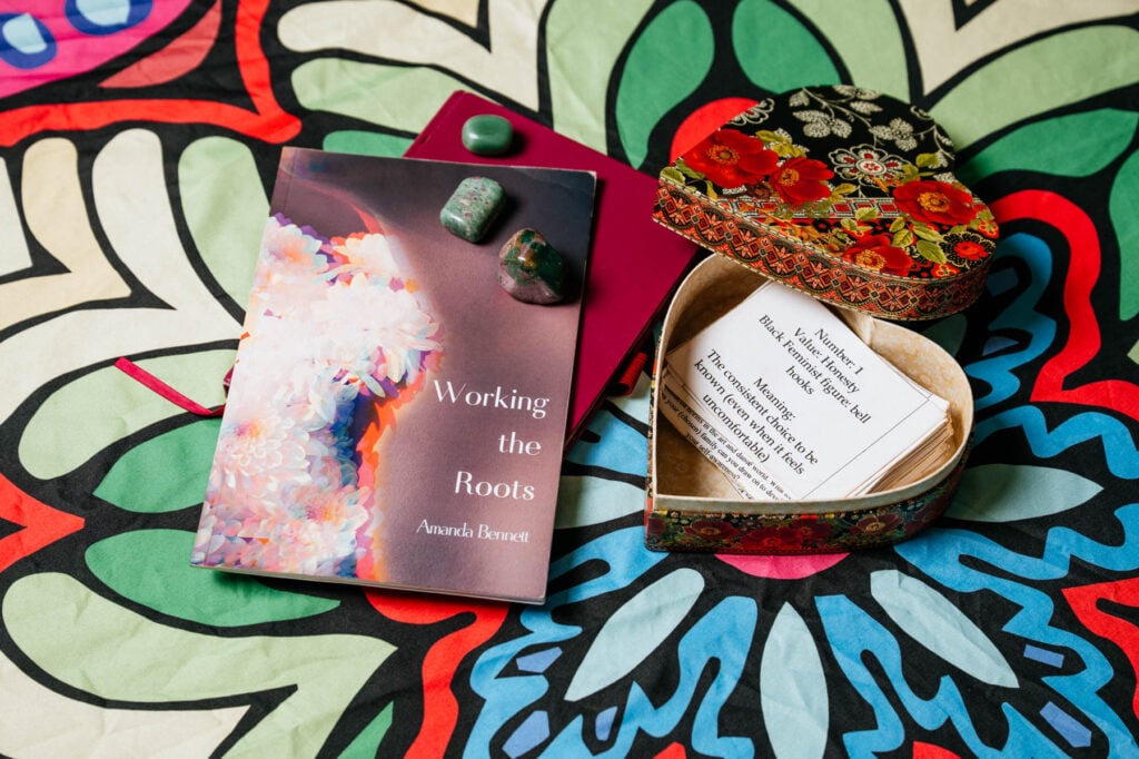 Amanda Bennett's book "Working the Roots," sits alongside an oracle deck.