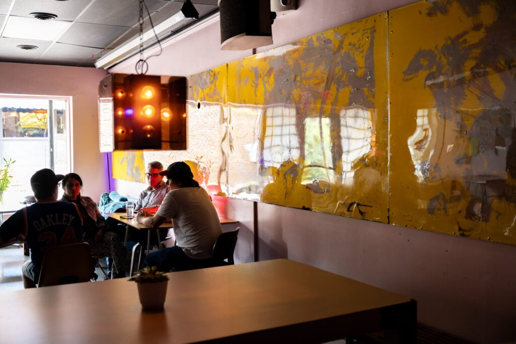 Four people sit at a table inside OCSC
