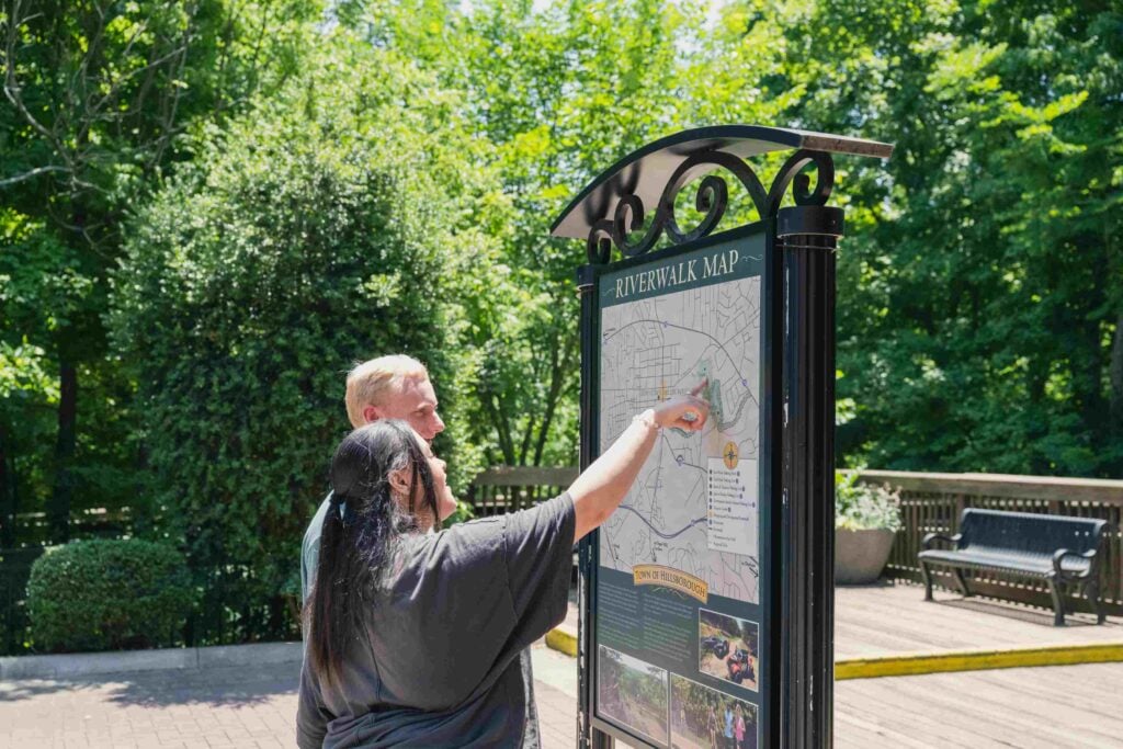 Emma Murphy and Morgan Gildersleeve study a map of the Riverwalk on a scavenger hunt organized by The Colonial Inn.