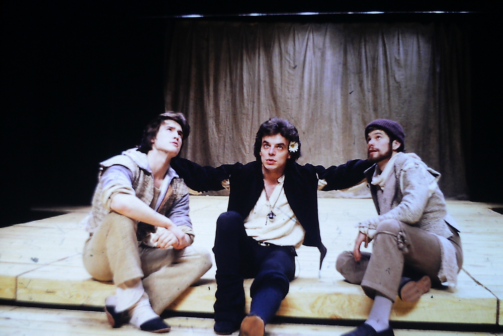 Three actors sit onstage during a PlayMakers 1978 production of "Hamlet"